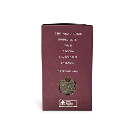 organic herbal tea in a deep burgundy color, featuring white text listing ingredients like tulsi, bacopa, lemon balm, and lavender